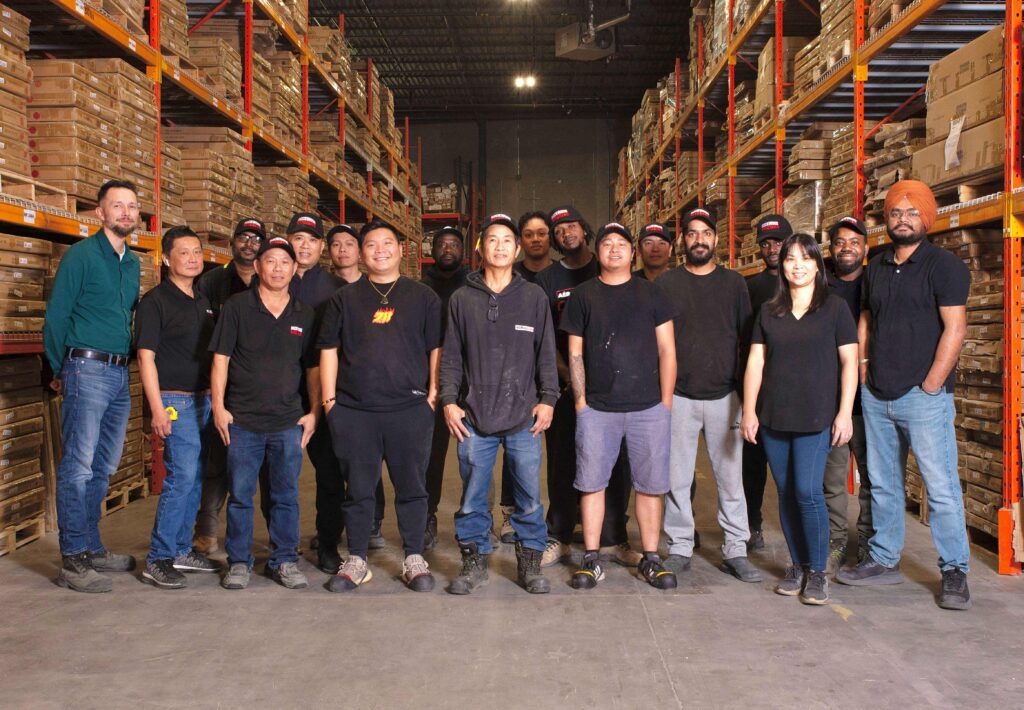 RockWood Kitchen's Warehouse team standing together in the warehouse.